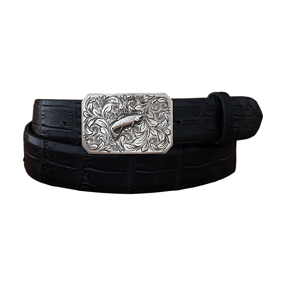 A black crocodile-embossed leather belt with a large, ornate silver-toned buckle featuring a detailed trout hand engraved design and swirling floral patterns, shown on a plain white background.